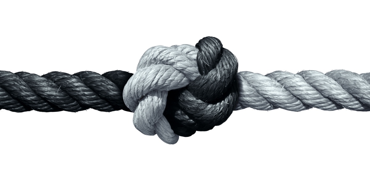 Black and white rope tied in a knot.