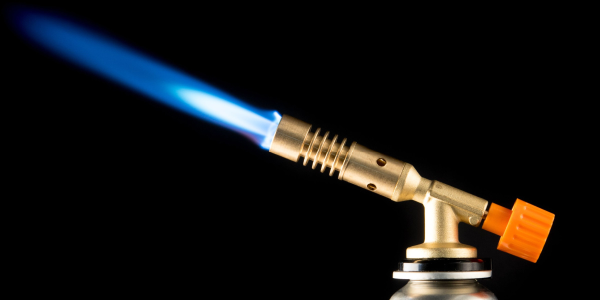 Blowtorch with blue flame and orange adjustment knob on a black background.