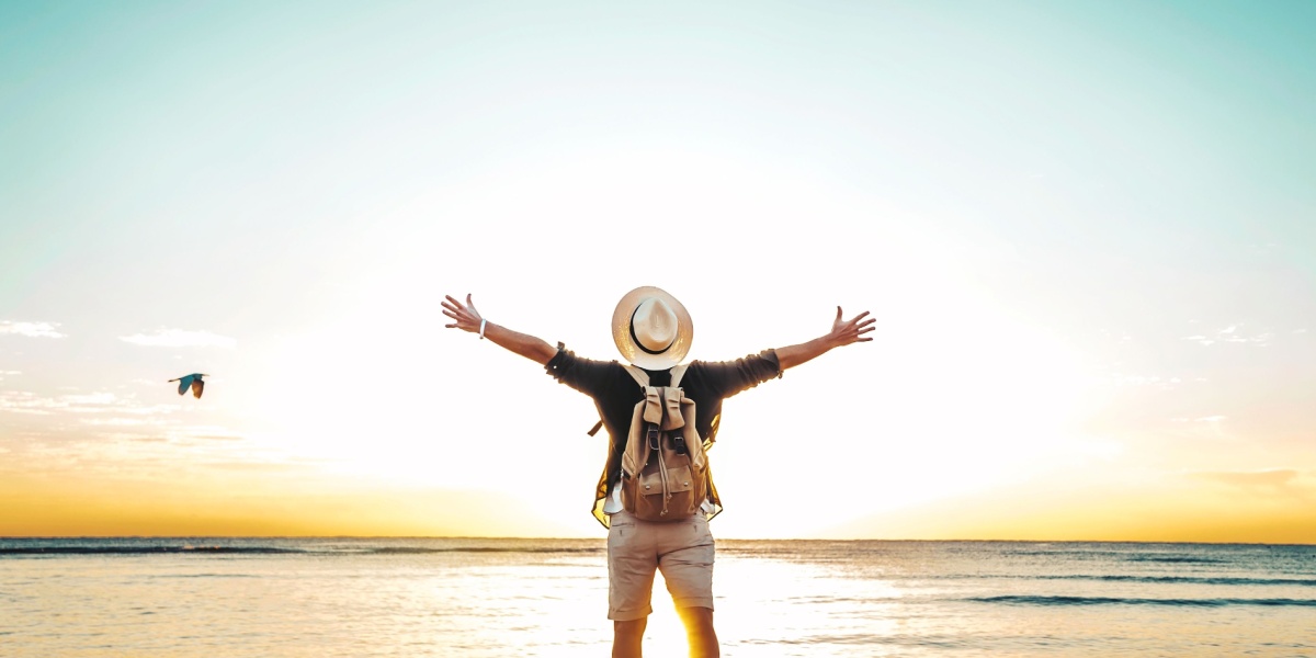 a man triumphantly looking into the horizon as he feels empowered being successful with his relapse prevention