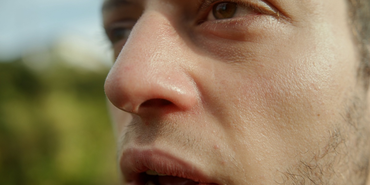 a close up of a man experiencing rapid breathing and blurred vision as symptoms of adderall overdose