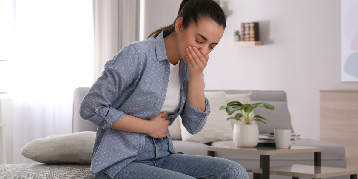 a woman suffering from nausea due to kratom side effects