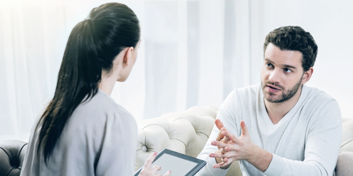 a half-body shot of two people in an office for a solution-focused therapy session