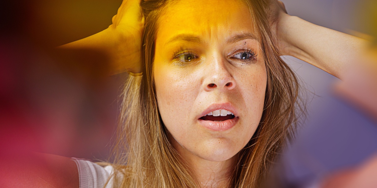 a close-up photo of a caucasian woman who looks confused and overwhelmed due to overamping