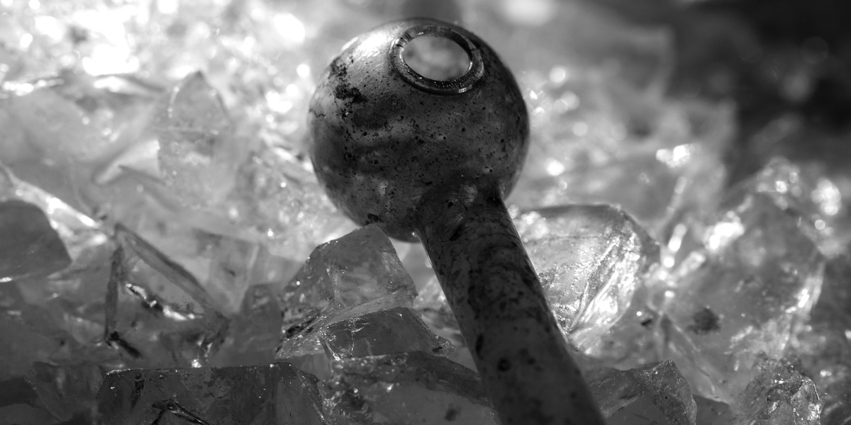a black and white close up photo of meth crystals of p2p meth and a meth pipe