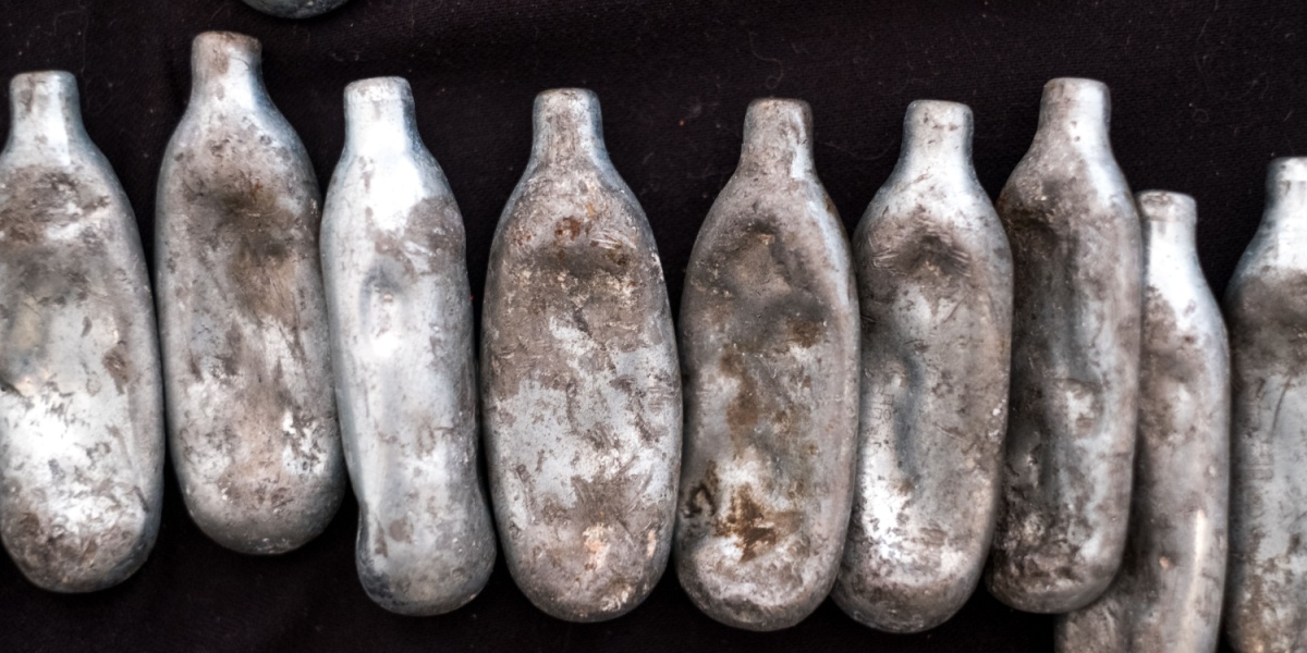 a photo of worn and muddy whippet canisters lined up