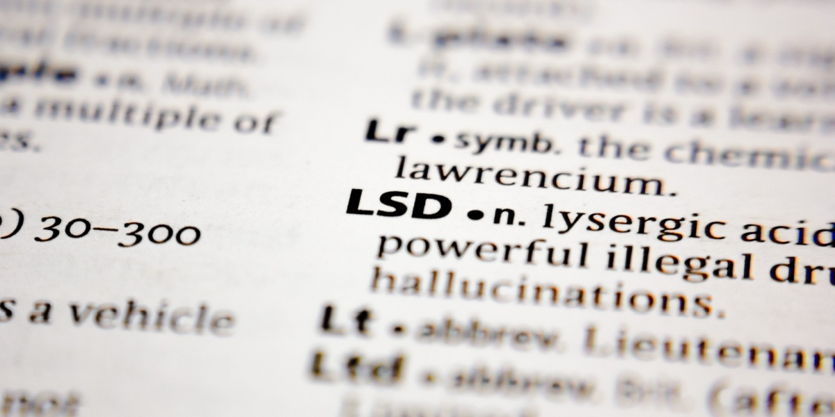a close up photo of the word LSD and its definition on the dictionary, the word