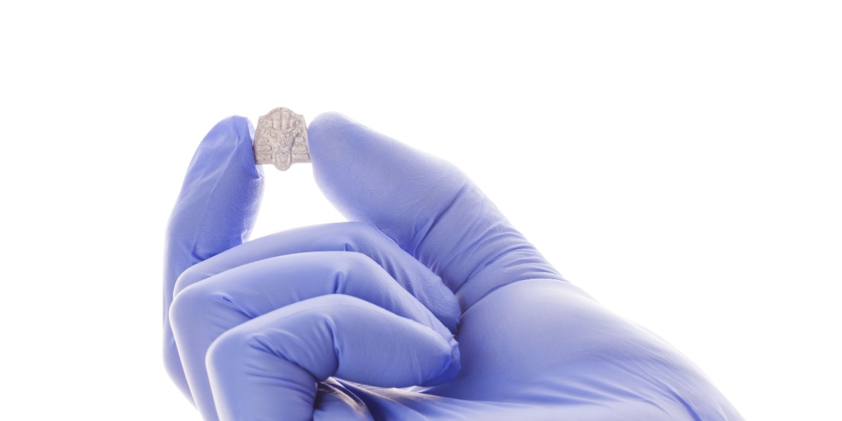 a close up of a purple gloved hand with a microdose of MDMA