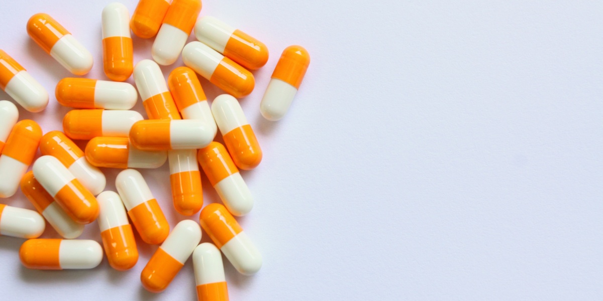a photo of Vyvanse capsules spread out on a light background on the left side of the frame