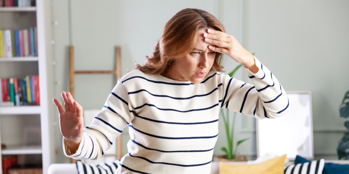 a half-body photo of a Caucasian woman in striped long sleeves, suffering from vertigo due to venlafaxine withdrawal