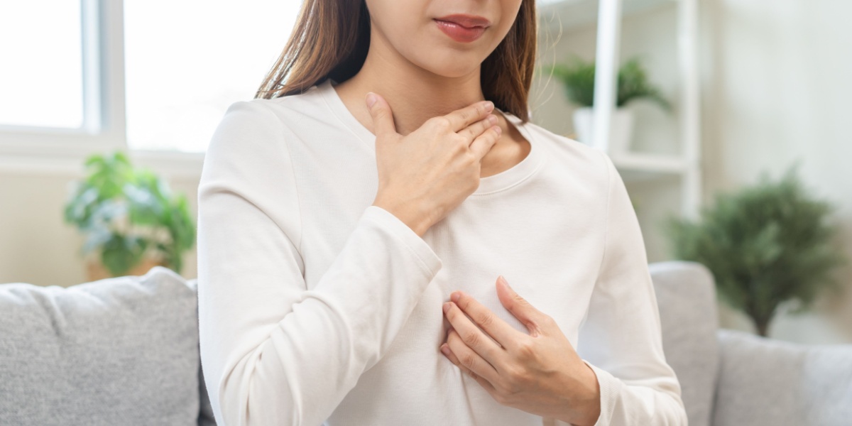 a photo of an unidentified woman suffering from Flexeril side effects like acid reflux and dry mouth