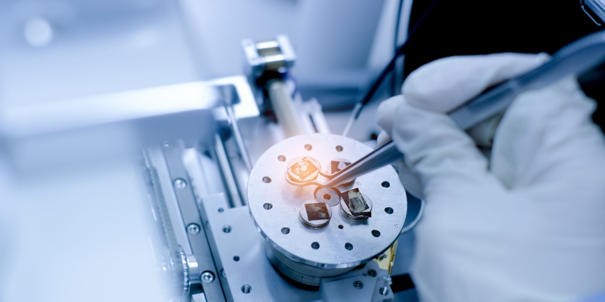 a photo of a closeup of a scientist's hand preparing nanomaterials in a laboratory